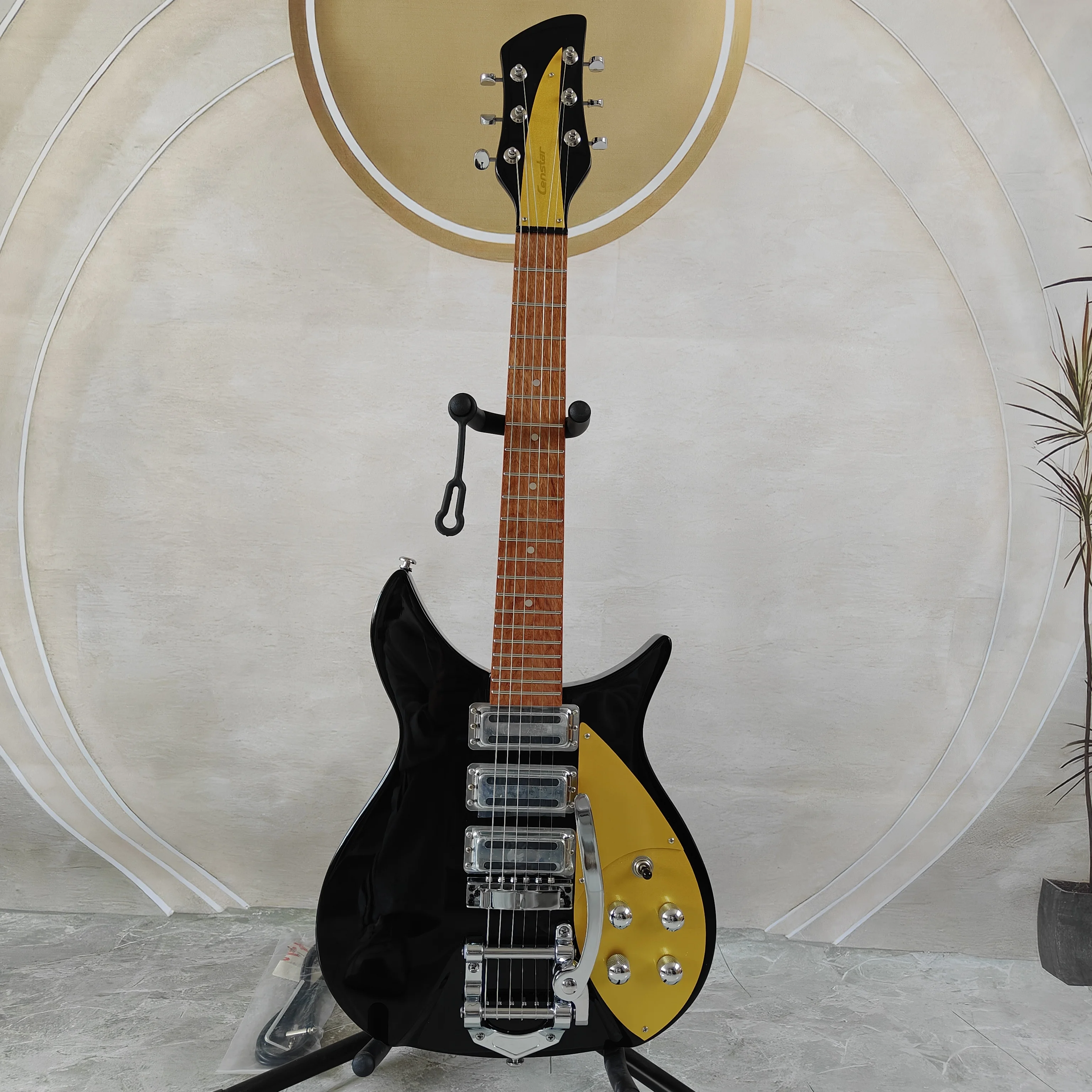 High-gloss polished black precision-shaped electric guitar with contrasting yellow top and three single-coil pickups, an all-rou