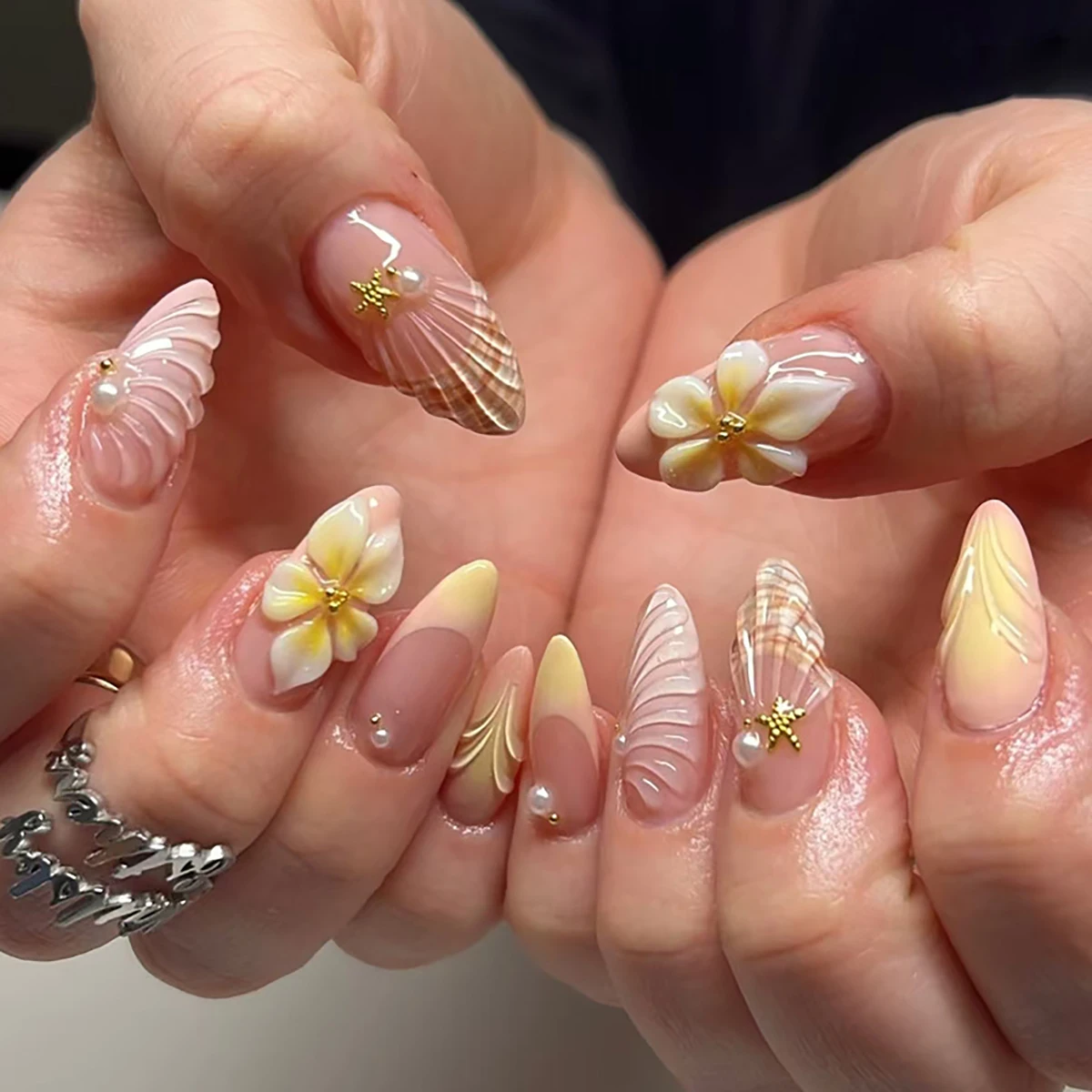

Handmade almond nails with nude pink gradient, decorated with 3D shells, plumeria flowers & pearls. Reusable, perfect for daily