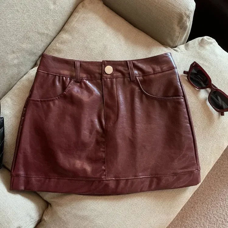 Wine red PU leather skirt half skirt for women, 2024 autumn and winter anti glare A-line hip hugging short skirt