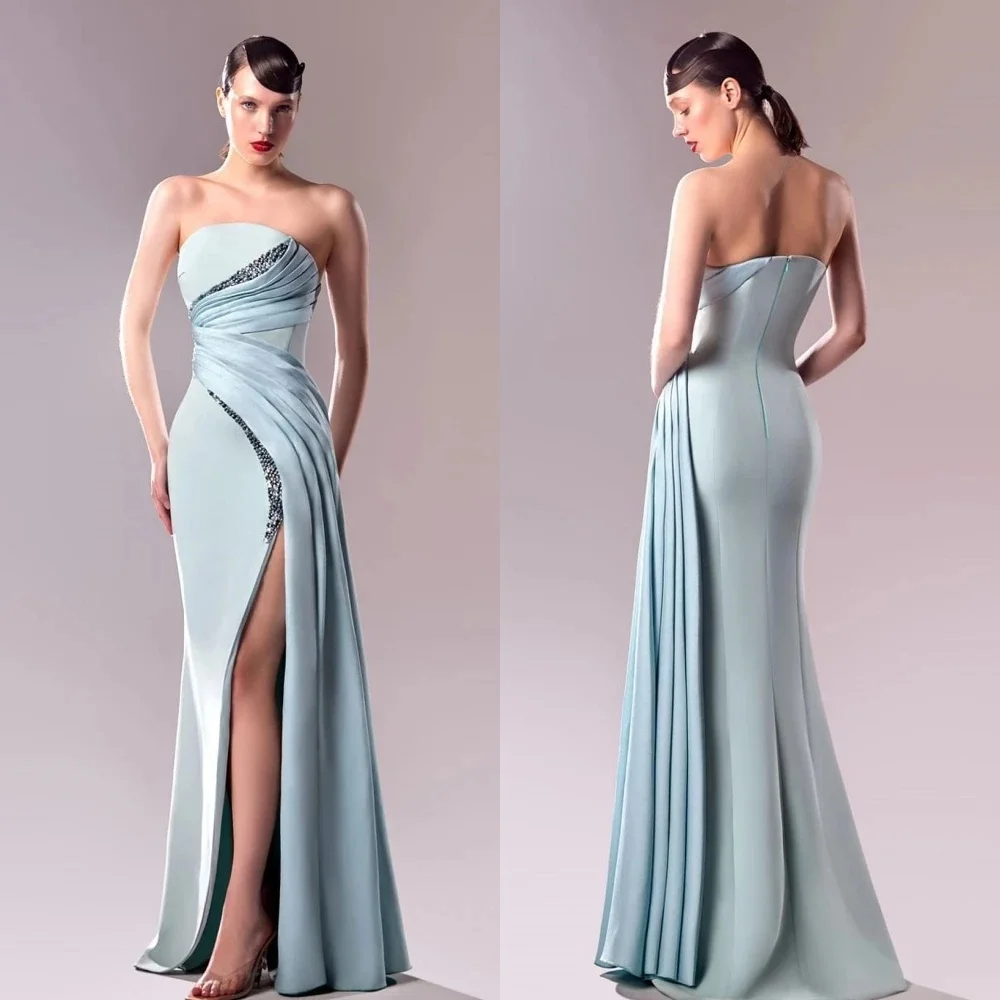 

Custom strapless floor-length gown with tight waist design to shape figure. Front slit lengthens leg line, crafted from lustrous