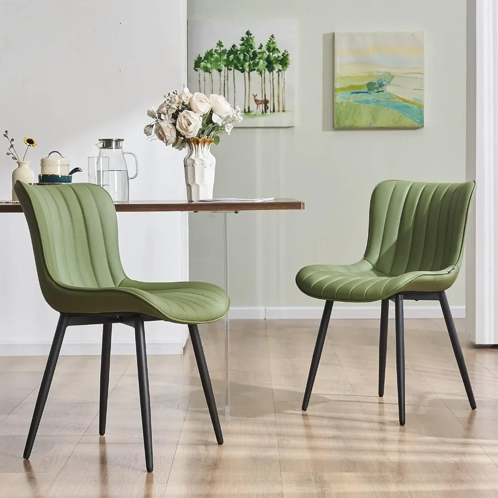 A set of 2 cushioned green dining chairs with armless faux leather edges and cushioned metal backrests