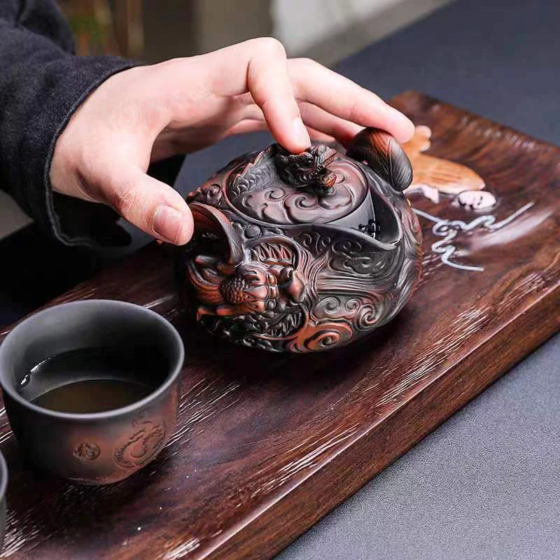 

Yunnan purple pottery pile carving flying dragon hand grab pot travel tea set one pot two cups kung fu tea set