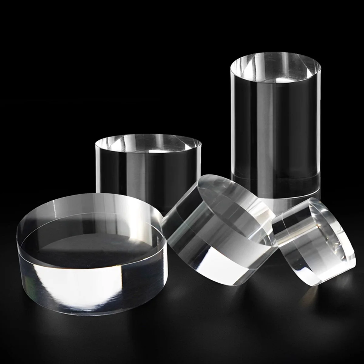 Clear cylindrical display riser pedestal for cosmetic and jewelry showcase
