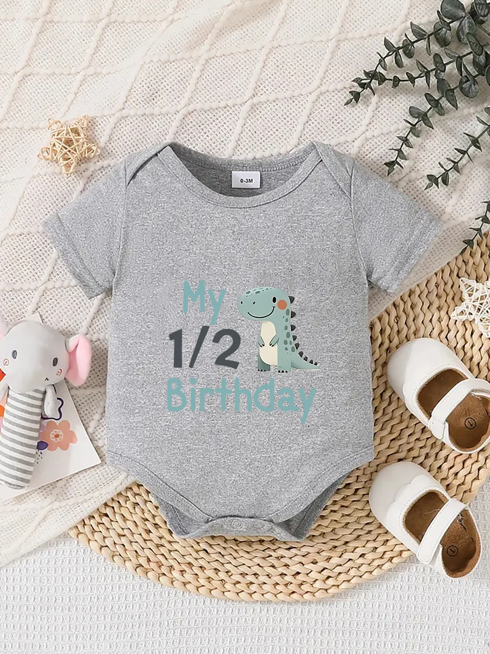 Playful letter-printed baby short-sleeve triangle bodysuit. Button closure for easy dressing, machine washable