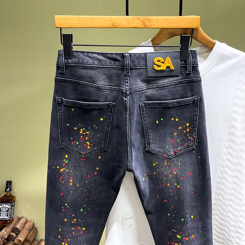 2024 spring and summer trend of fashion printing spray paint jeans men's Slim small straight leg pants personalized hole pants