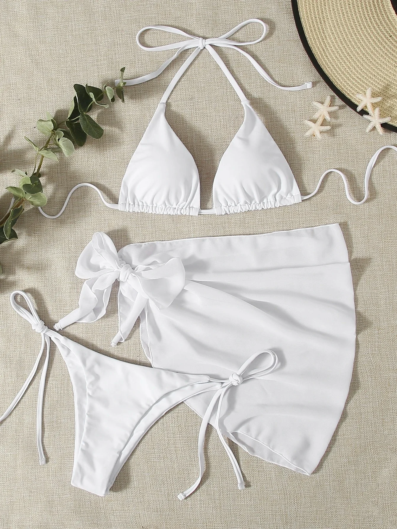 

White Halter Triangle Bikini With Side-Tie Bottoms And Wrap Skirt Set