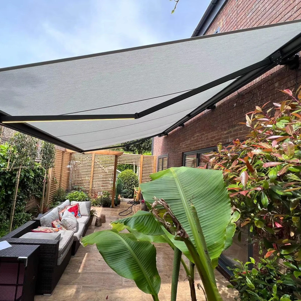 Automatic retractable acrylic cassette-style canopy with full frame, folding arms and LED lighting