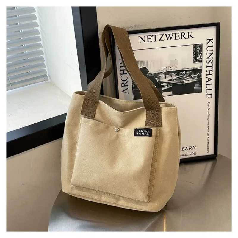 2025 جديد قماش بسيط سستة المرأة مصمم حقيبة يد شعبية بلون العصرية سستة عادية حسن المظهر حقيبة كتف