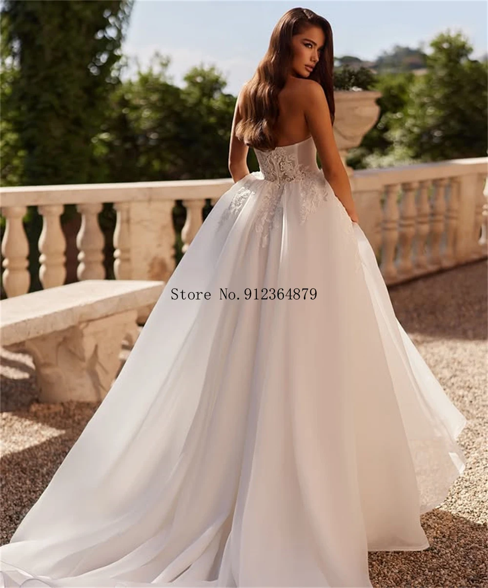 فستان زفاف مخصص بدون حمالات مزين بالدانتيل مع خط عنق على شكل قلب وقطار طويل فستان زفاف أنيق