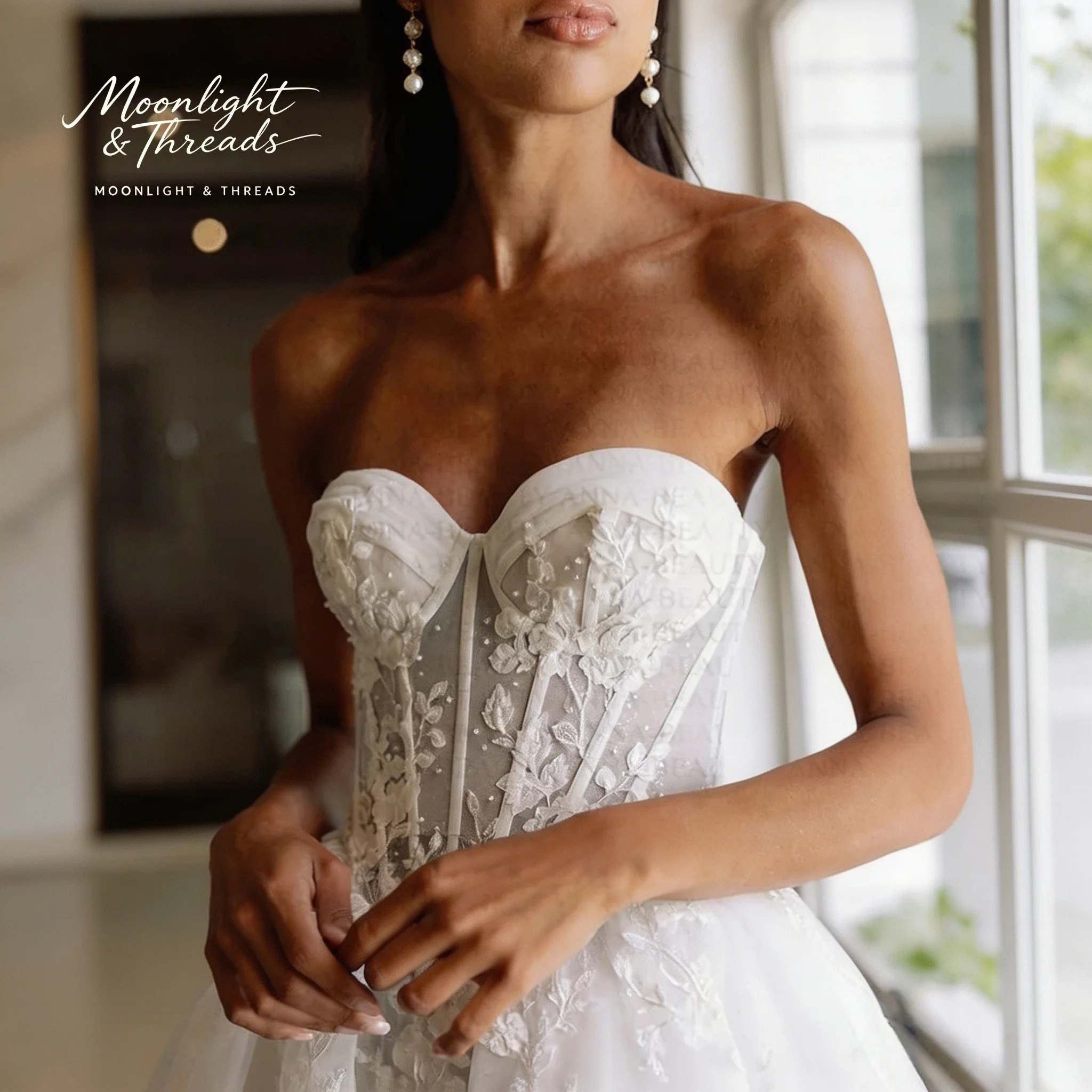 

White strapless sleeveless floor-length ball gown for formal weddings featuring exquisite lace embroidery and internal boning