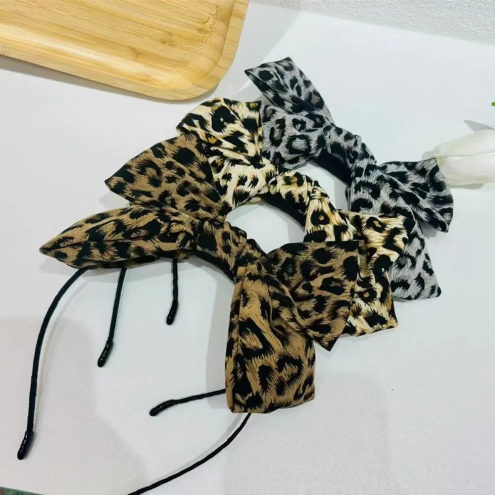 

Элегантная тканевая повязка на голову с леопардовым принтом и бантом для женщин
