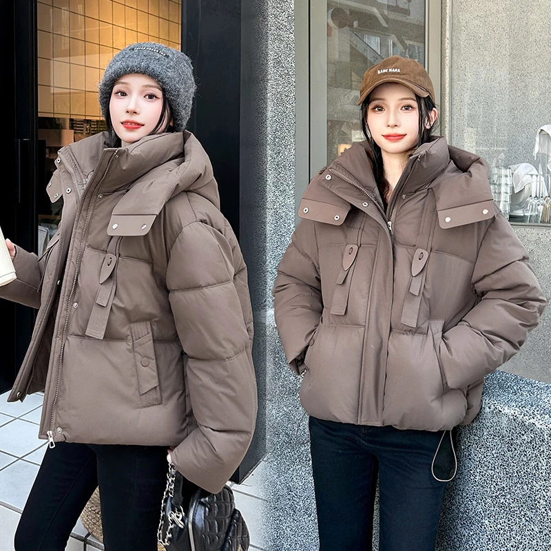 2025 Nuova giacca corta in cotone con design a nastro invernale da donna spessa Parka cappotti manica lunga tasche con cerniera con cappuccio abbigliamento casual tendenza