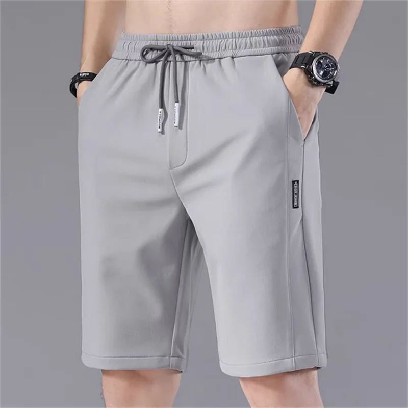 Pantalones cortos deportivos para hombre, Shorts informales de cintura elástica, holgados, con patrón liso, para correr, verano, 2024