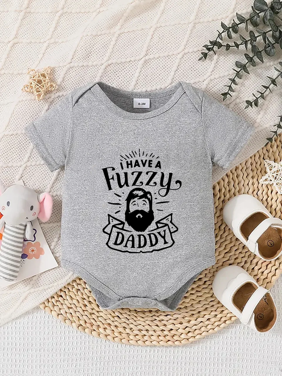 Playful letter-printed baby short-sleeve triangle bodysuit. Button closure for easy dressing