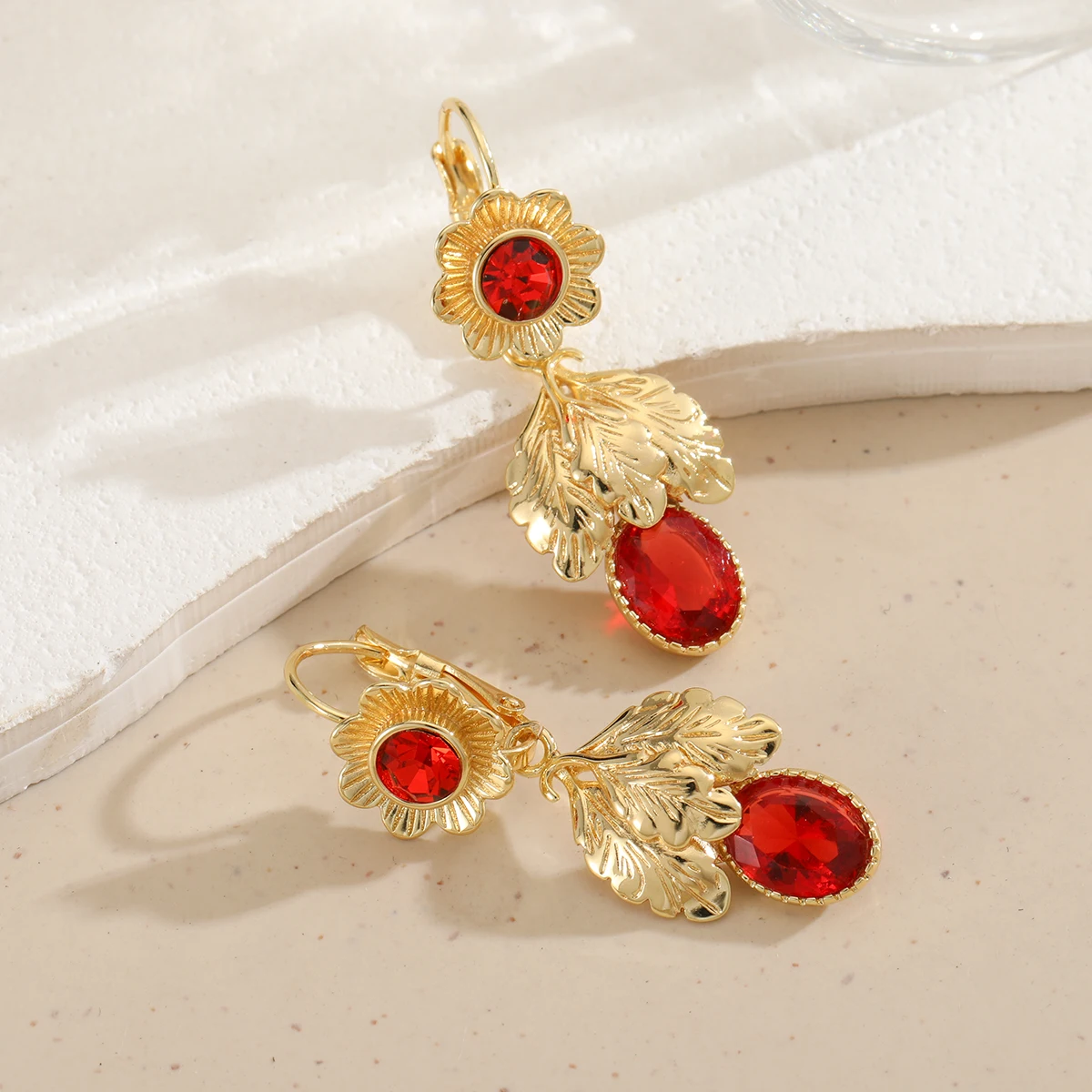Retro-style copper earrings with red artificial gemstones and floral designs, suitable for casual travel wear.