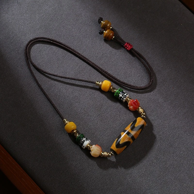 

Tibetan Double Tiger Tooth Tianzhu Pendant Hand woven Hanging Rope with Multi colored Matching Beads Retro Ethni
