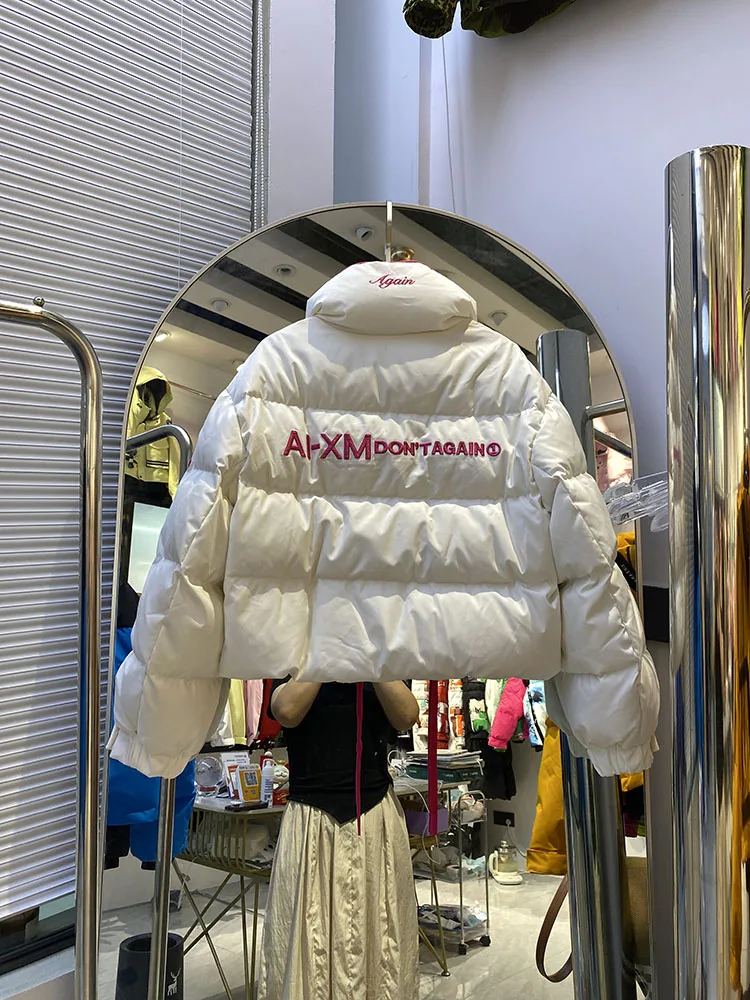 Chaqueta de plumón cálida con capucha para mujer, chaqueta de plumón de pato blanco a la moda con temperamento elegante, novedad de invierno de 2025
