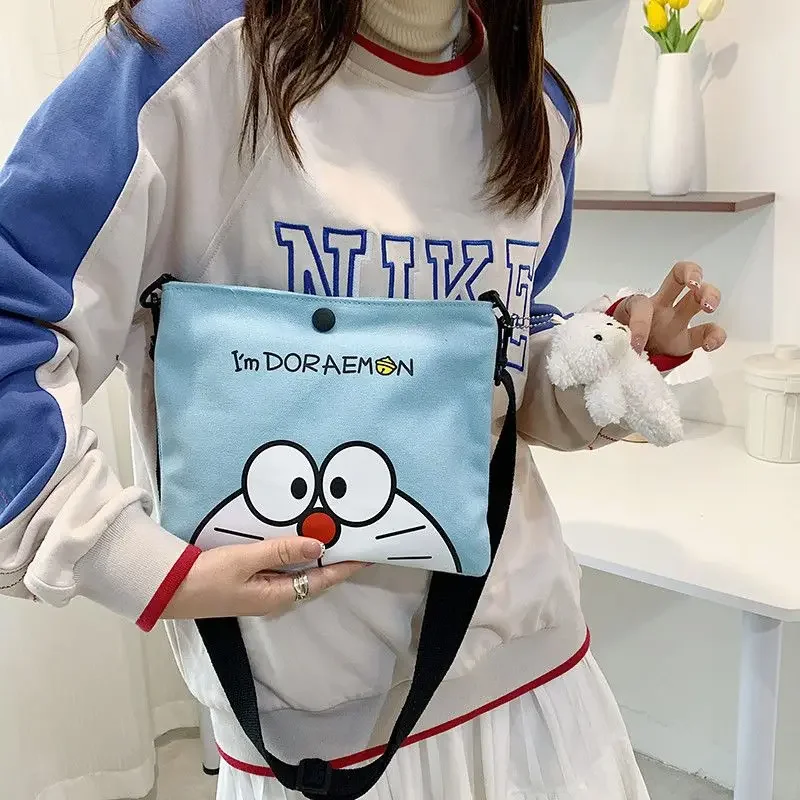 Popularne anime Doraemon płótno z nadrukiem kreskówkowym mała torba uroczy robot kot torba na ramię crossbody torba do przechowywania artykułów piśmienniczych prezent