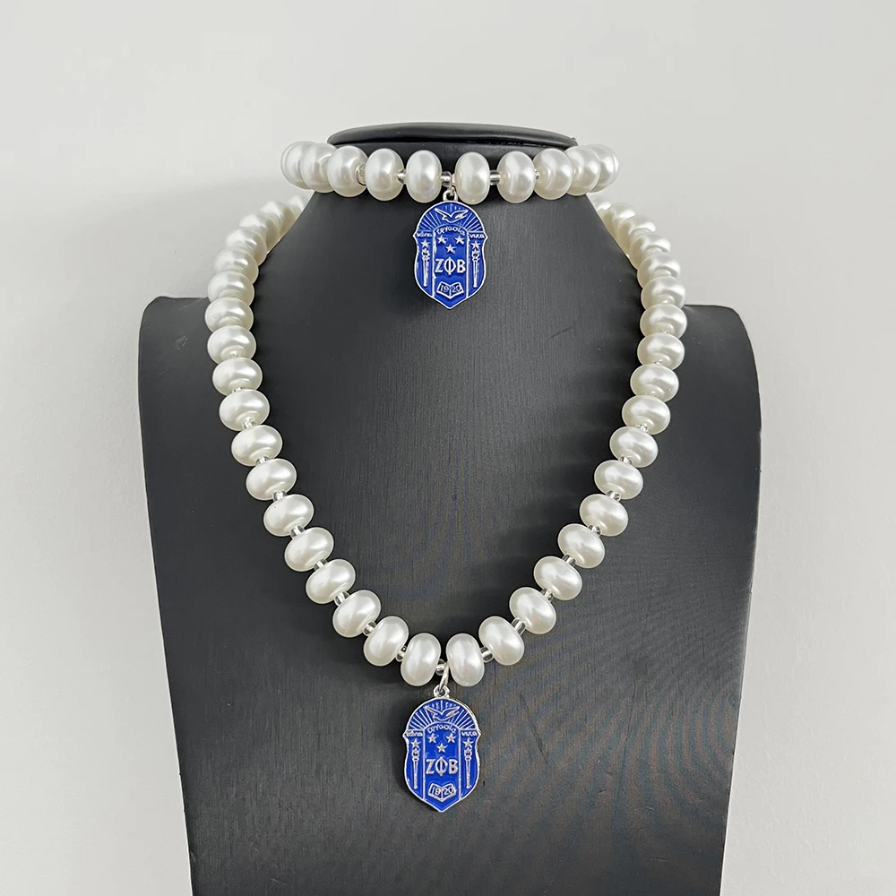 The ZOB Royal Blue Shield Pendant with Pearl Bracelet Necklace Set is designed specifically for Zeta Phi Beta Sorority women.