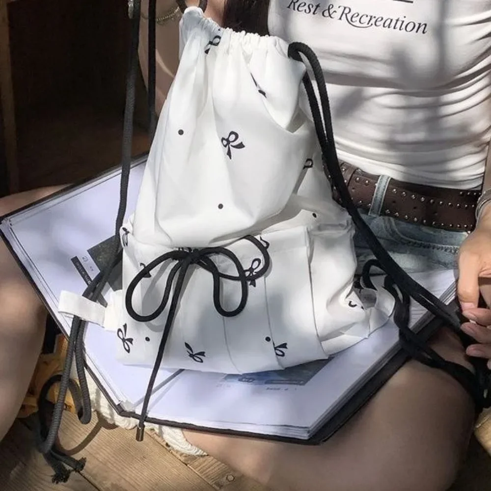 

Korean Tie Up Bow Y2k Aesthetic Simple Cute Backpack Sweet Bow Print Drawstring Casual White Backpack Women Mochilas Para Mujer