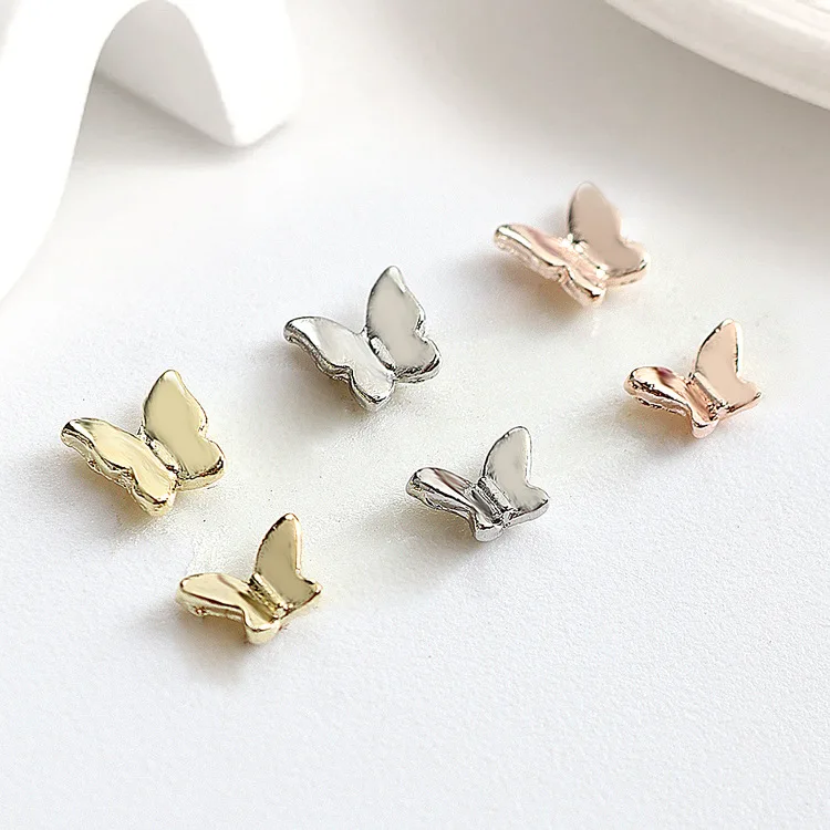 Nowy 50 sztuk / worek Francuska róża Złoty stop Biżuteria motylkowa Mini 3D Błyszczący metal Mały motyl Diy Nail Art Charms Dekoracje