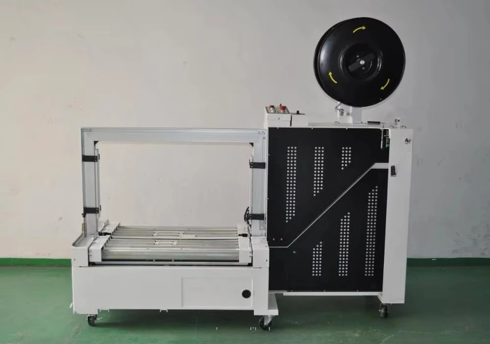 MH102B Low table baler with conveyor. Integrated conveyor line for efficient packaging flow.