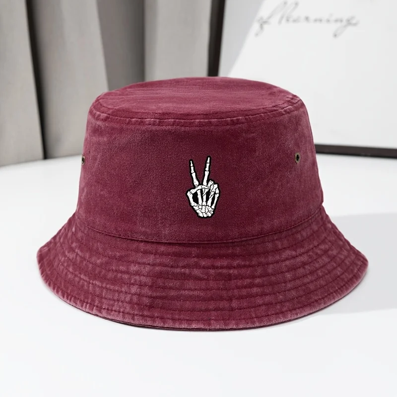 A Stylish Fisherman'S Hat with a Skull Hand, Perfect for Outdoor Travel. This Vintage Washed Cap Features a Worn-Out Look, Casua
