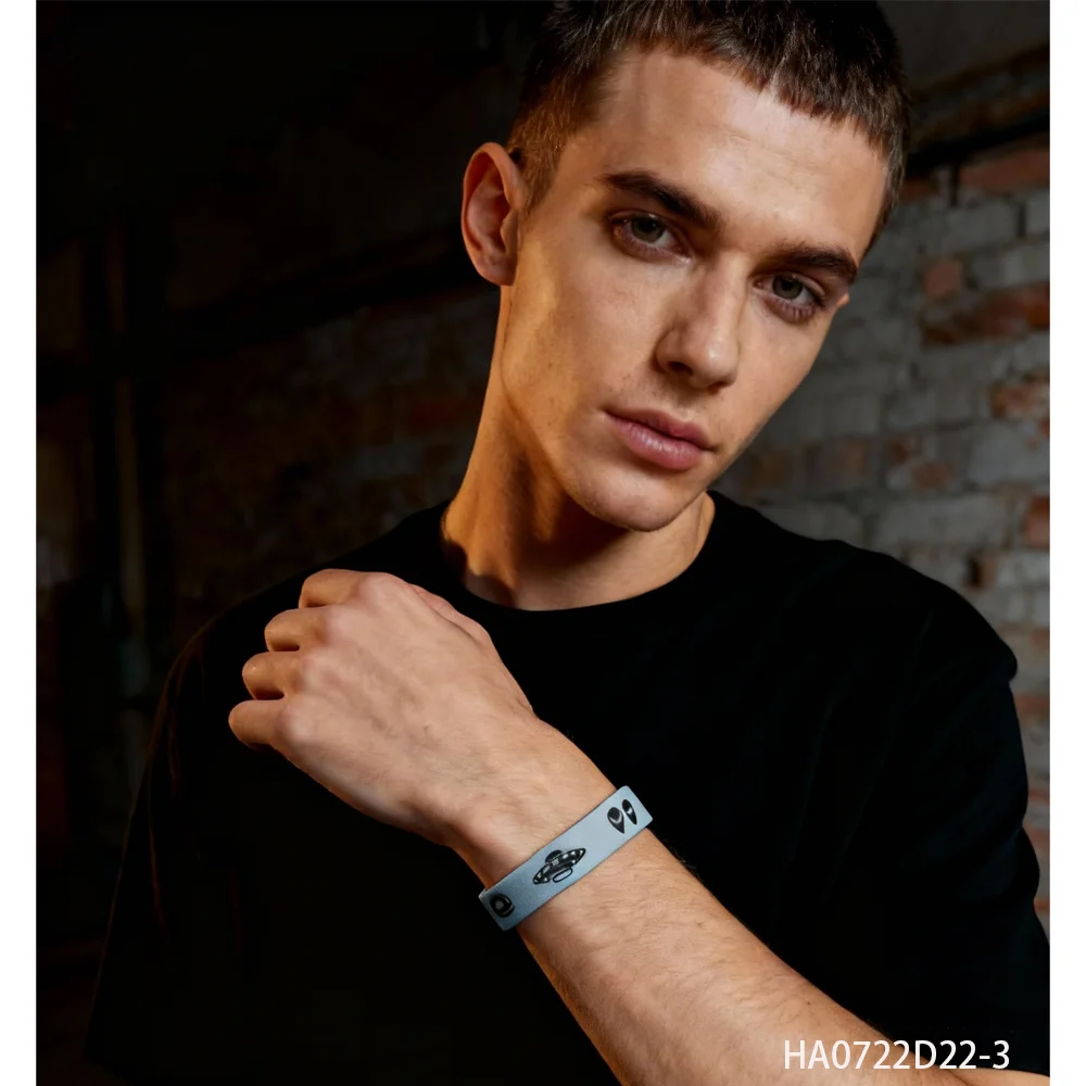 PESENAR   This is a light blue silicone bracelet printed with black aliens flying saucers planets and other sci fi elements