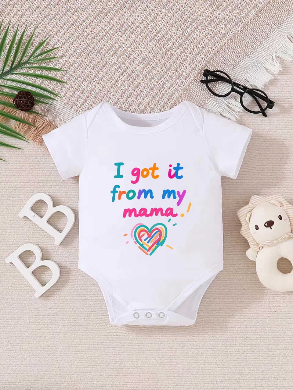 Playful letter-printed baby short-sleeve triangle bodysuit. Button closure for easy dressing, machine washable