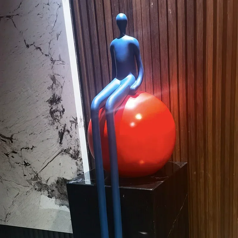 Long legged figures with large floor to ceiling decorations, living room foyer, lobby, model room, staircase