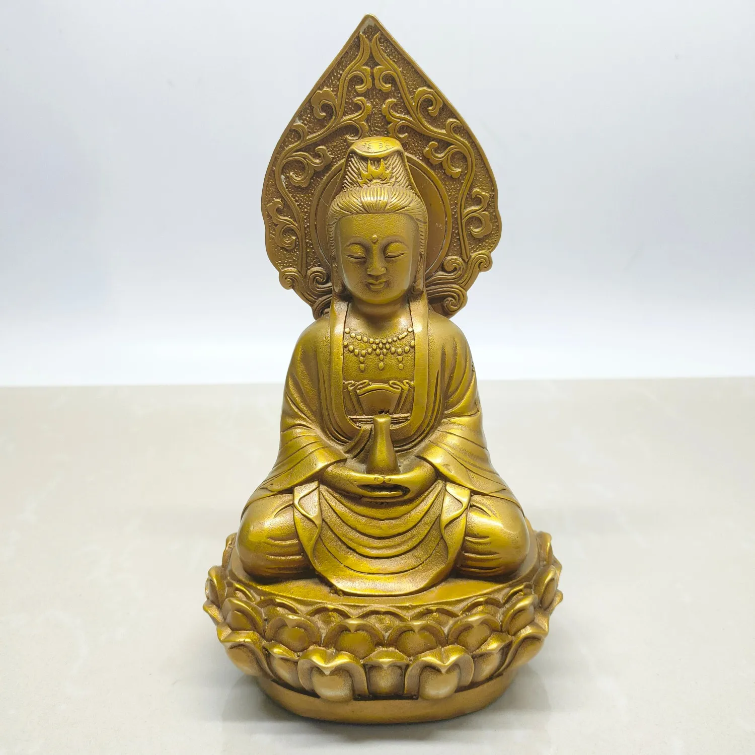 

A small Guanyin figurine made of antique brass with an aged and vintage finish.,Free shipping