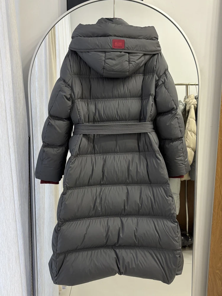 Elegant Long down jacket with hooded women's 2026 Winter High quality warm puffer coat with sashes Female outwear INKEO DJ640