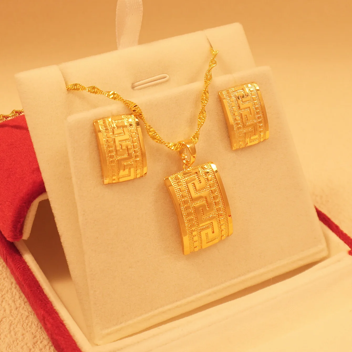 9999 gold love jewelry from a Middle Eastern Dubai lady. Square-shaped pendant earrings. A graduation season gift.