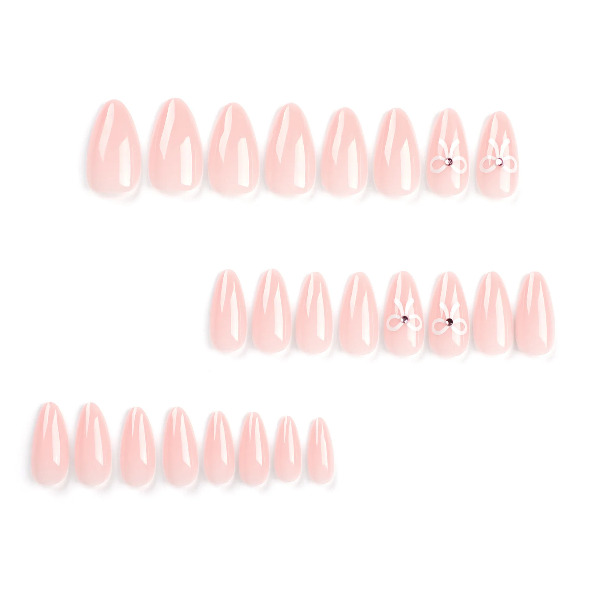 The complete set of 24 long almond shaped pointed nails features a simple white bow and a three-dimensional rhinestone design in
