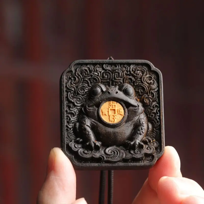 Agarwood pendant with a golden toad inlay, finely carved to attract wealth and treasures, a cultural item for one's zodiac year,