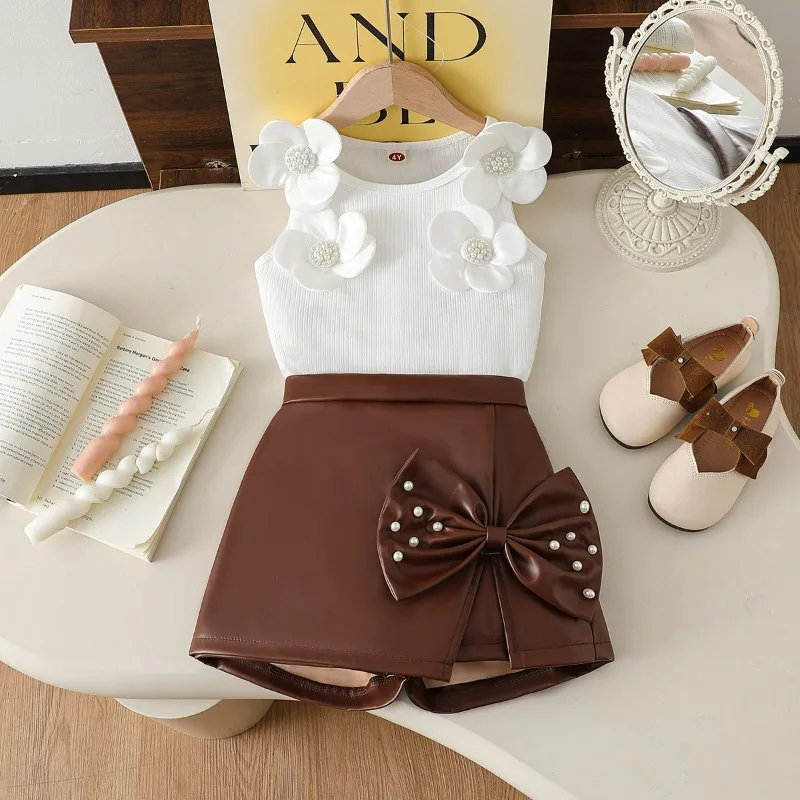 

Комплект для девочек 2026: модный топ с цветочным принтом и асимметричная кожаная юбка с бисером и бантом