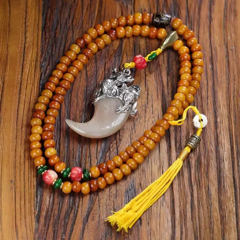 Natural apple bead necklace with a horn-shaped copper pendant and ivory accents