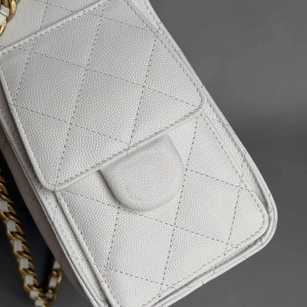 Off-white caviar leather quilted drawstring bucket bag, flap with side pocket design, interwoven gold chain strap, medium capacity, an elegant crossbody, shoulder, and hand-carry bag for women.