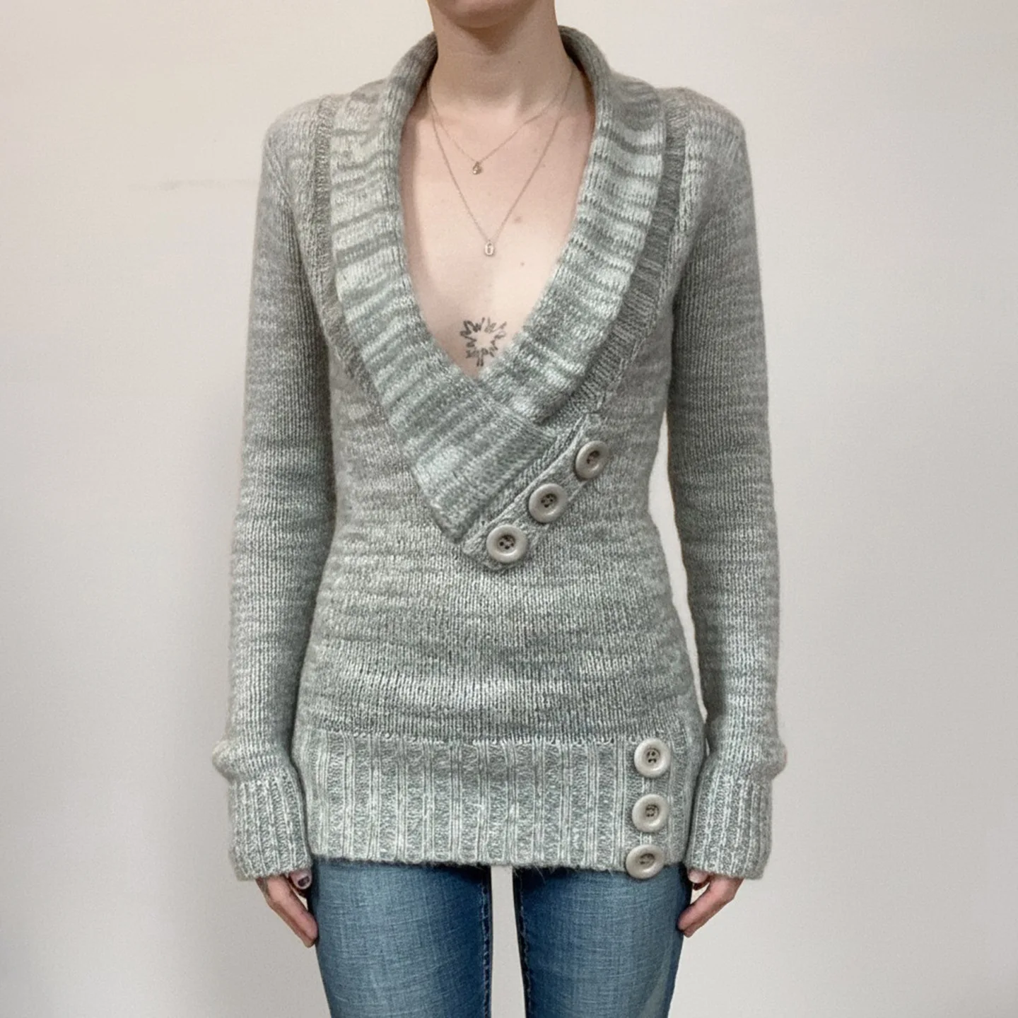 

A Mid-length Sweater With A Cinched Waist And Slimming Effect, Decorated With Buttons, Is A Stylish, Unique And Versatile Top