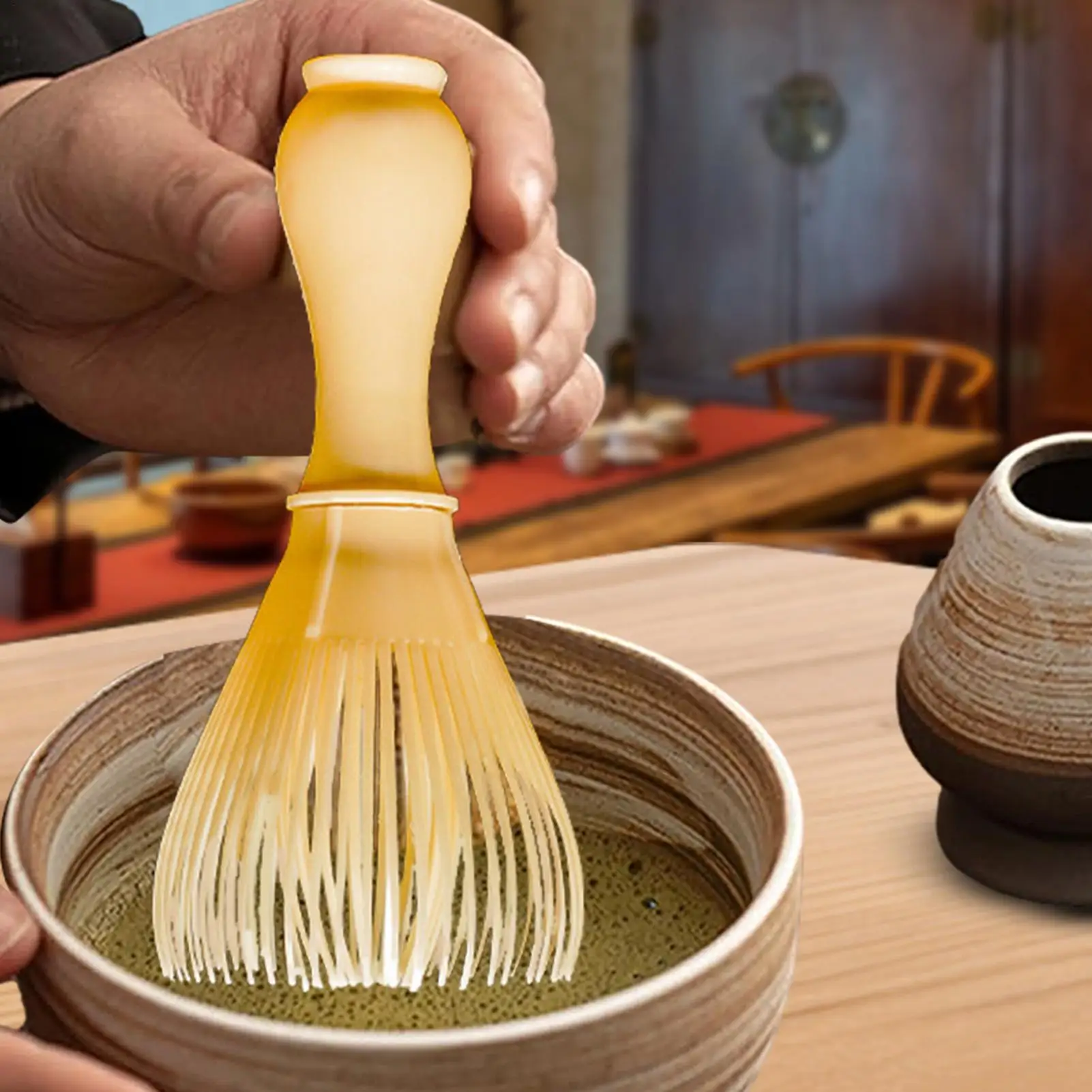 matcha stirring mixer frothing whisk traditional tea muddling tool craft creamy matcha latte during indoor tea preparation work