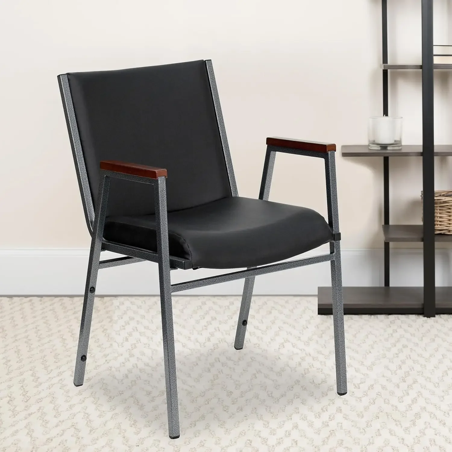 HERCULES Series Heavy Duty Black Vinyl Stack Chair with Arms and Ganging Bracket
