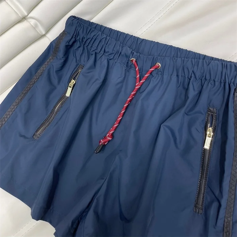 Pantaloncini da donna di colore blu in Nylon U699616 abbigliamento donna di alta qualità primavera estate Streetwear elastico in vita allacciatura in corda Design nuovo