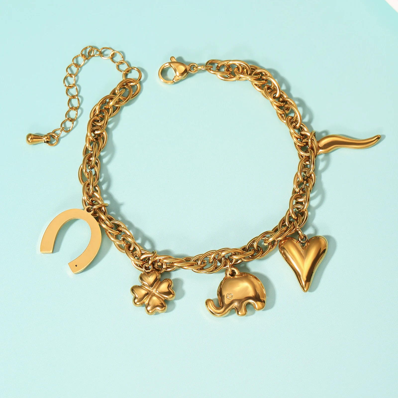 

Golden Tone Stainless Steel Cuban Chain Charm Bracelet with Elephant Clover and Heart Pendants for Women
