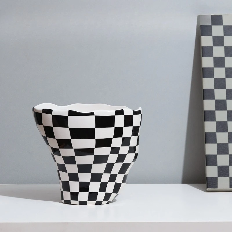 

Irregular black-and-white checkerboard, tall-footed glazed vase floral device