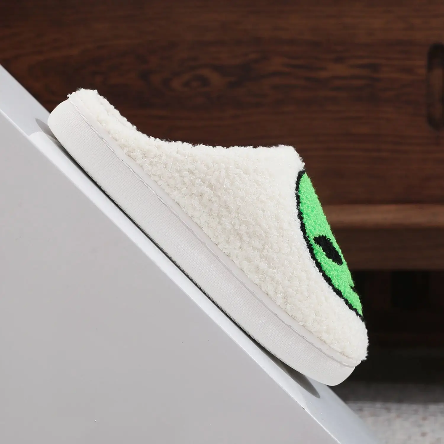 A pair of alien patterned winter home cotton slippers non-slip thick-soled wool slippers comfortable indoor shoes for men and women can wear