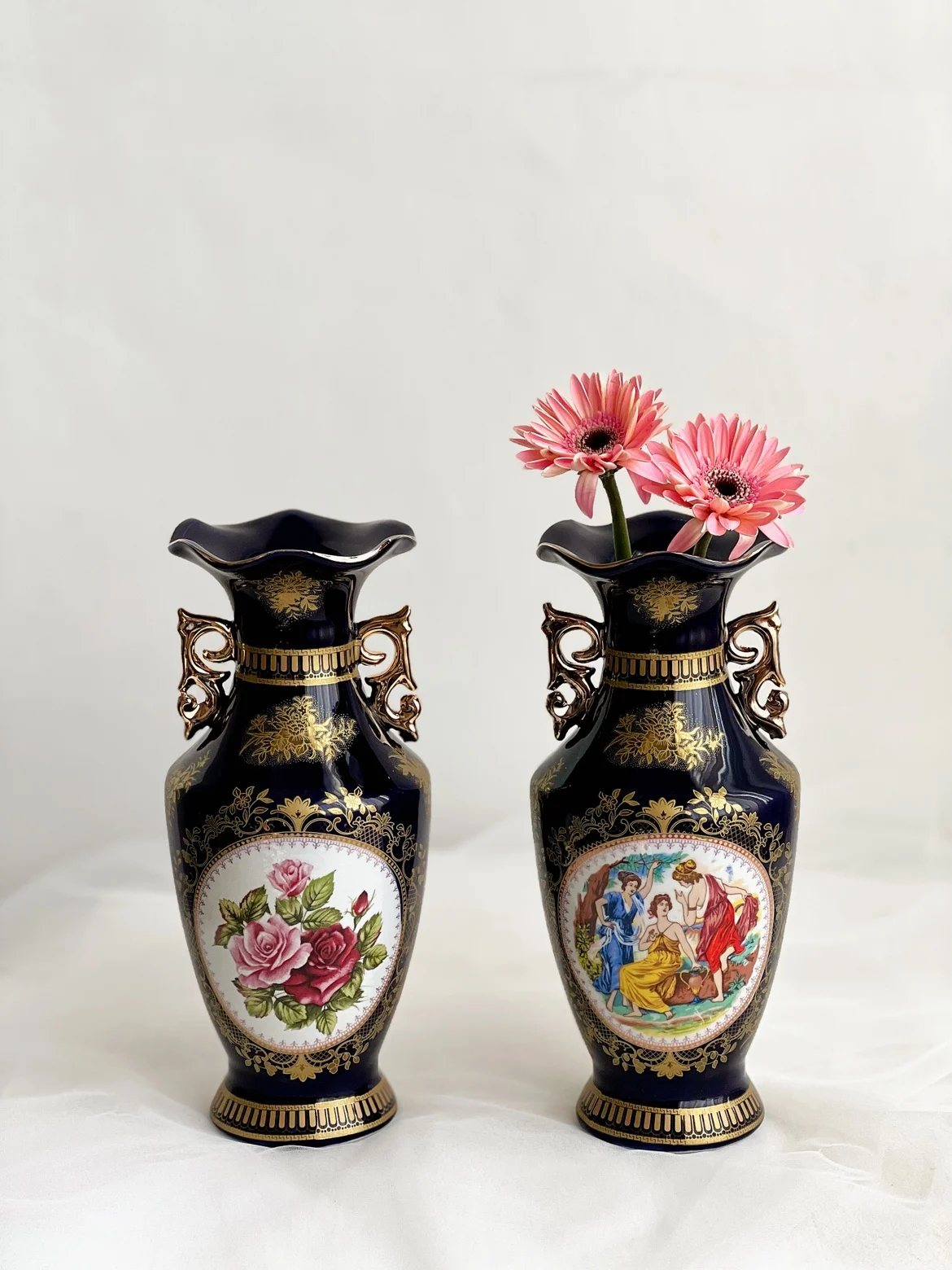 Vintage European style vase with blue glaze, featuring figures, flowers, and ceramic vases