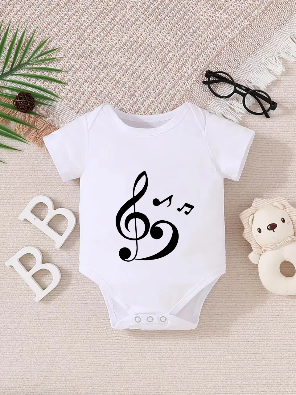 Playful letter-printed baby short-sleeve triangle bodysuit. Button closure for easy dressing, machine washable
