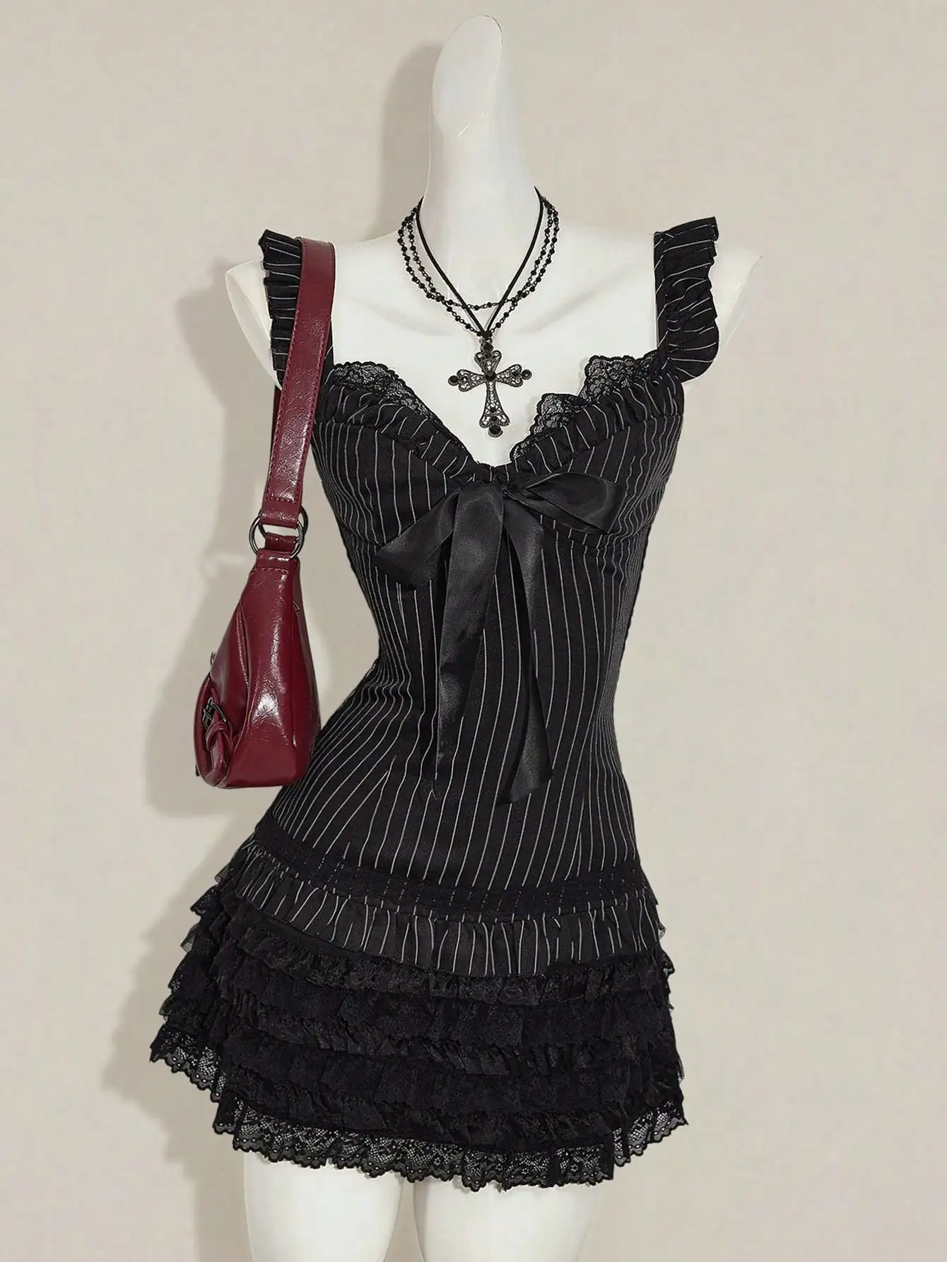 

Черное мини-платье в готическом стиле с кружевными оборками, в полоску и с бантом