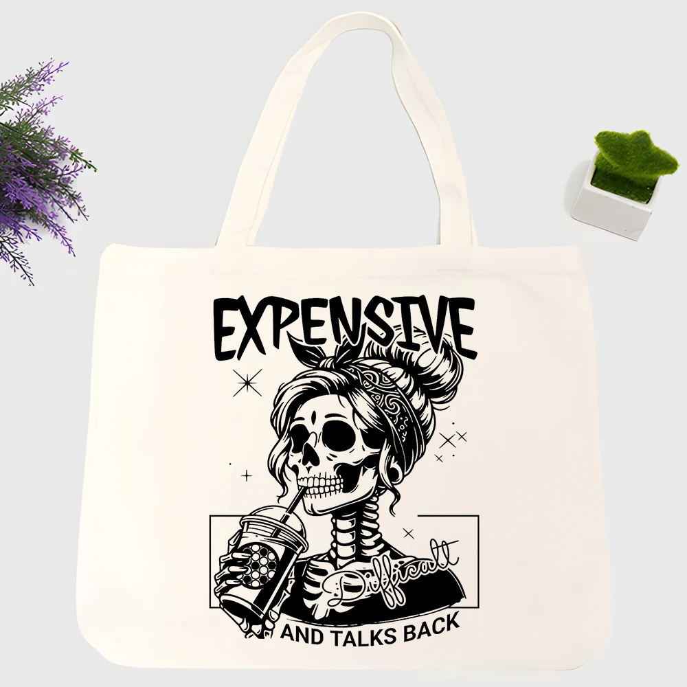 Women's skull graphic canvas tote bag with letter print, ideal for casual daily use and weekend outings