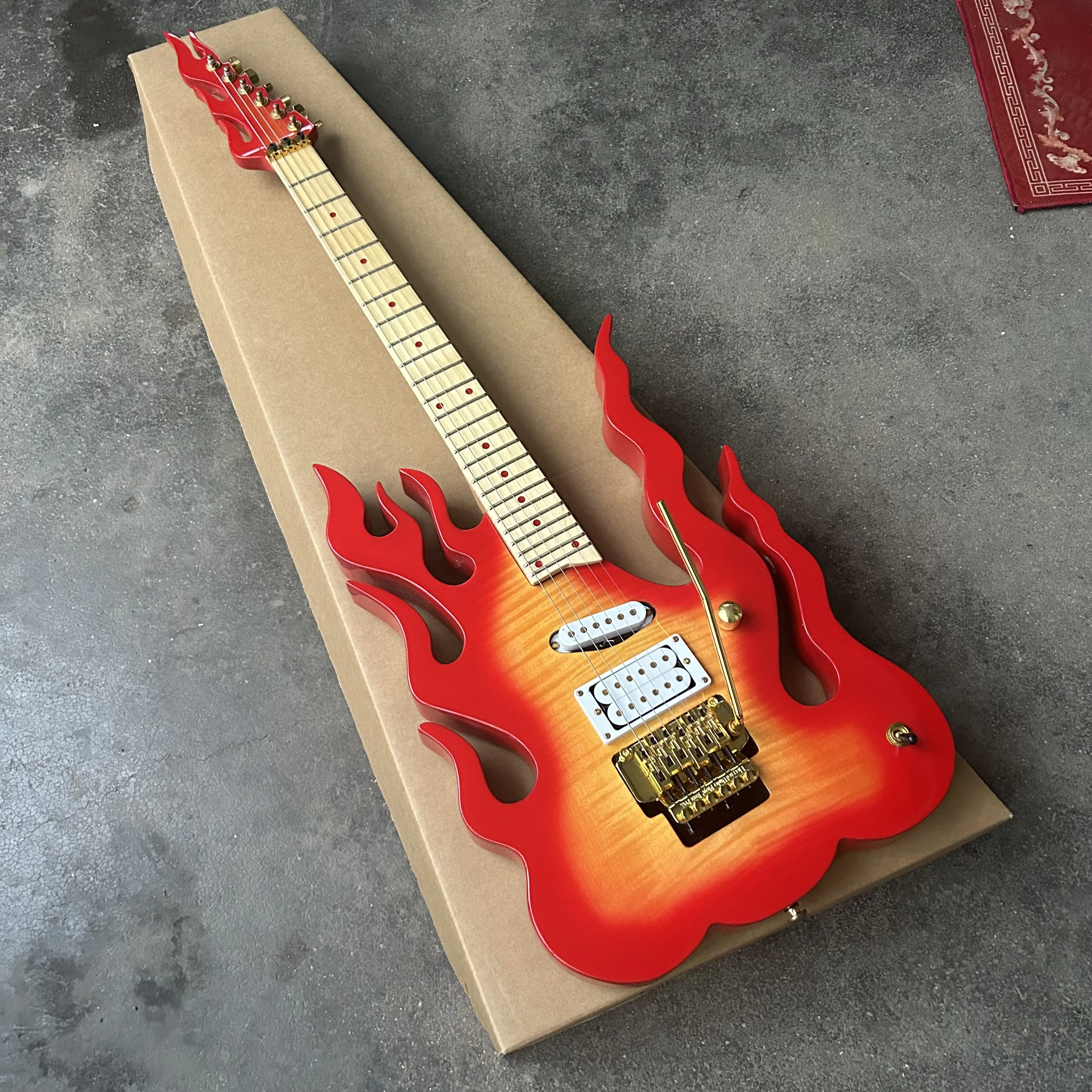 Inventory: New flame guitar, tiger-pattern painted guitar, with a tremolo arm.